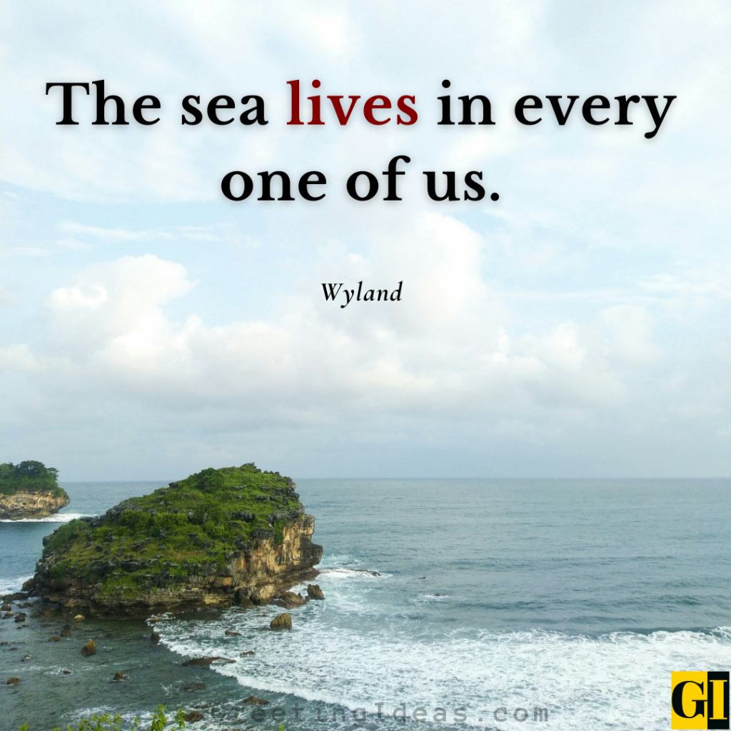 A rocky island covered in green foliage surrounded by deep blue ocean waves, capturing Wyland's quote on the deep sea and soul connection within us all